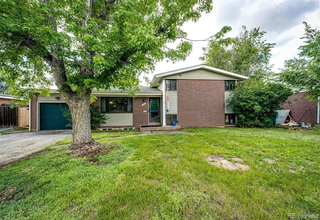 3111 Troy St, Aurora, CO 80011 - view of front of house with brick siding, an attached garage, and asphalt driveway