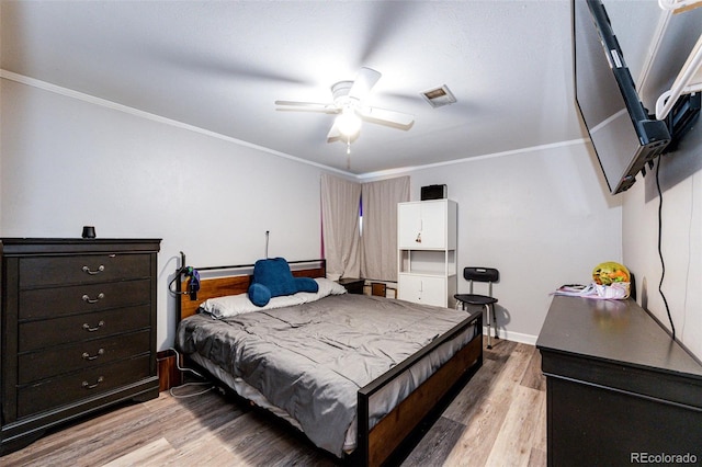 3111 Troy St, Aurora, CO 80011 - bedroom with light wood finished floors, crown molding, baseboards, and ceiling fan