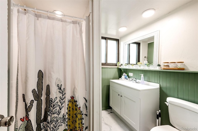 3111 Troy St, Aurora, CO 80011 - full bath with marble look tiles, vanity, toilet, and a shower with shower curtain