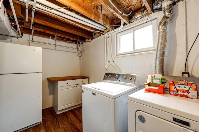 3111 Troy St, Aurora, CO 80011 - washroom featuring separate washer and dryer, dark wood-type flooring, and cabinet space
