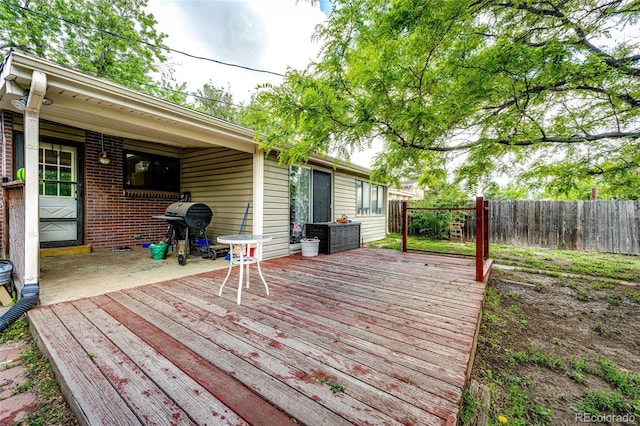 3111 Troy St, Aurora, CO 80011 - wooden deck featuring a grill and a fenced backyard