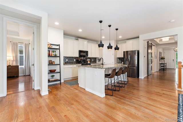 6046 Gilbert Way, Golden, CO 80403 - kitchen featuring black microwave, stainless steel fridge with ice dispenser, range, white cabinetry, and recessed lighting