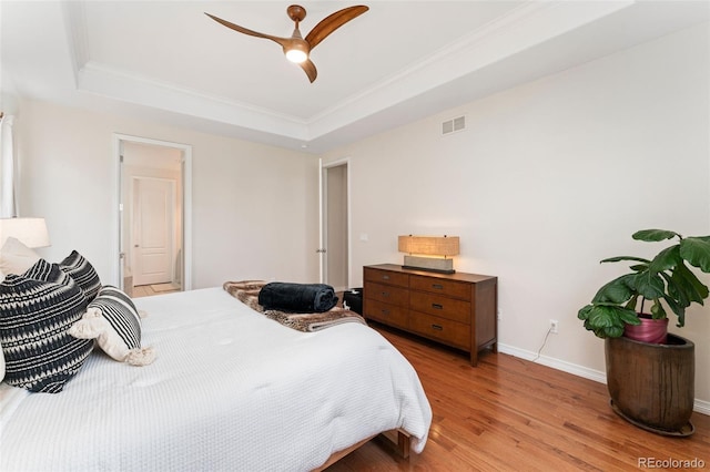 6046 Gilbert Way, Golden, CO 80403 - bedroom featuring a raised ceiling, wood finished floors, crown molding, and a ceiling fan