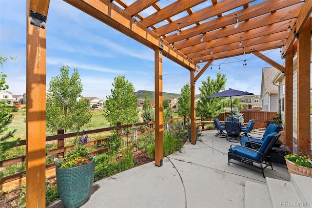 6046 Gilbert Way, Golden, CO 80403 - fenced backyard featuring a patio area, outdoor dining area, and a pergola