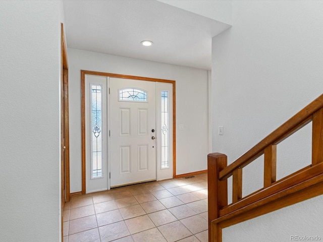 entryway with light tile patterned flooring