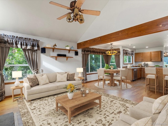 living room with ceiling fan, sink, high vaulted ceiling, and light hardwood / wood-style floors