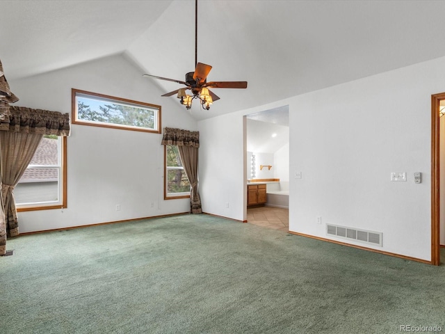 interior space featuring light carpet, lofted ceiling, and ceiling fan