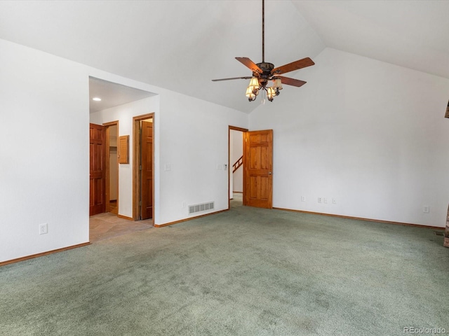 unfurnished bedroom with ensuite bath, vaulted ceiling, light colored carpet, and ceiling fan