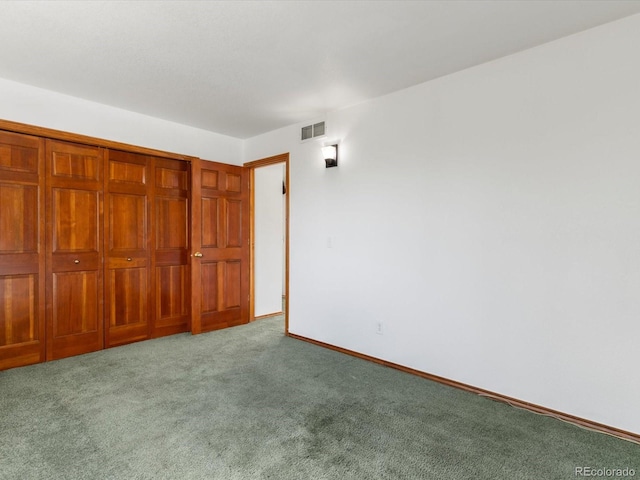 unfurnished bedroom featuring light carpet and a closet