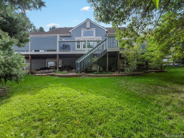 rear view of property with a deck and a lawn