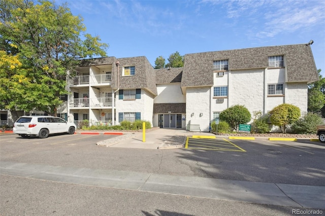 view of building exterior with uncovered parking