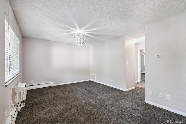 empty room featuring dark colored carpet, a textured ceiling, baseboards, visible vents, and a baseboard radiator