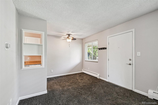 unfurnished room featuring a baseboard heating unit, a ceiling fan, a textured ceiling, and dark colored carpet