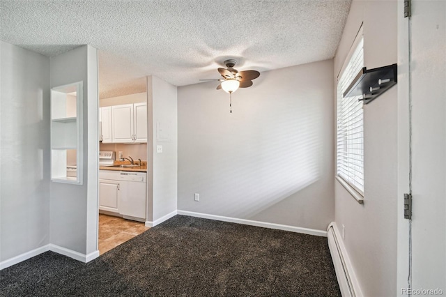 unfurnished dining area with light carpet, a sink, a textured ceiling, baseboards, and ceiling fan