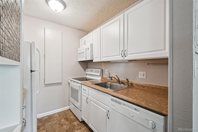 kitchen featuring a textured ceiling, white appliances, sink, and white cabinets