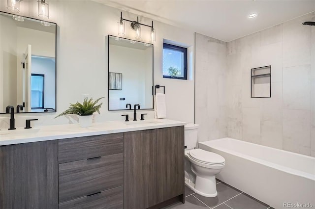 full bath with double vanity, a sink, tile patterned floors, toilet, and shower / bathtub combination