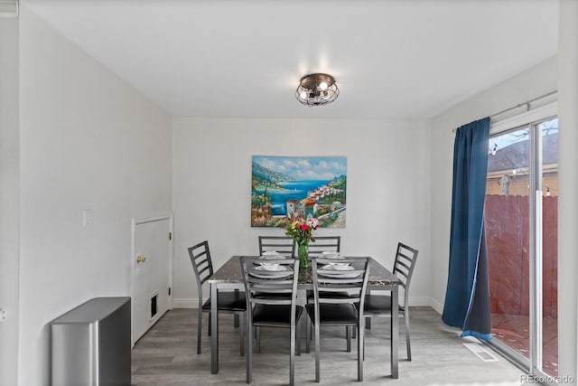 dining area with hardwood / wood-style floors