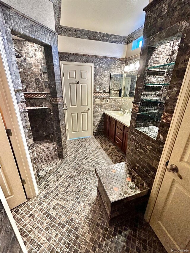 bathroom with vanity and a shower