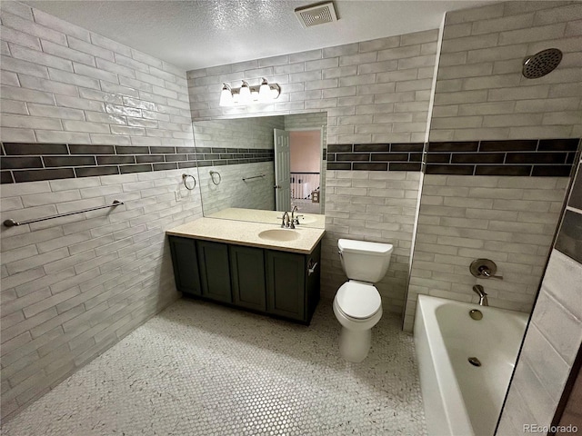 full bathroom with vanity, toilet, shower / bath combination, and a textured ceiling