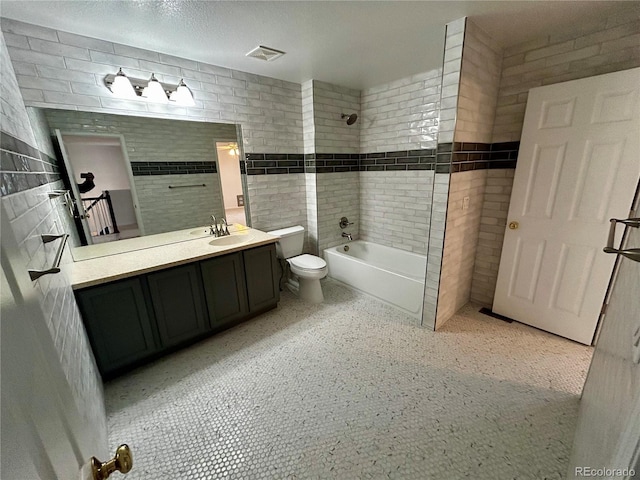 full bathroom featuring vanity, bathing tub / shower combination, and toilet