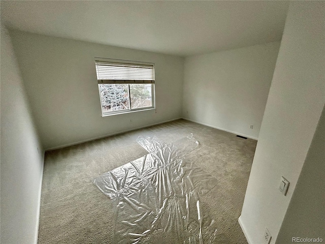 spare room featuring carpet floors