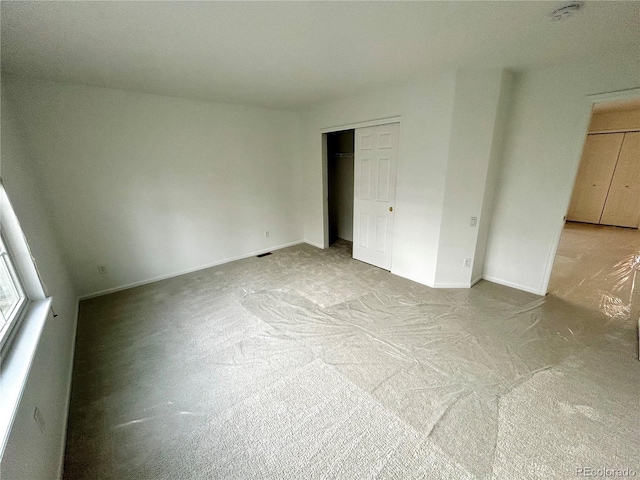 unfurnished bedroom with light carpet