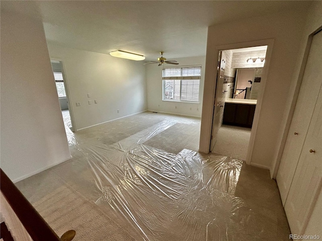 interior space with ceiling fan