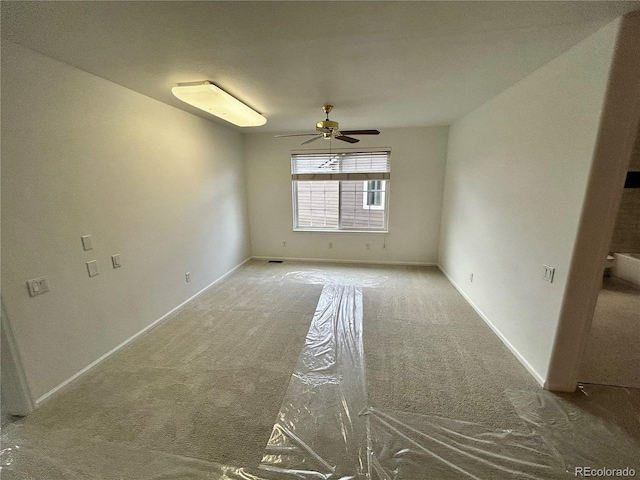 spare room featuring ceiling fan and carpet flooring