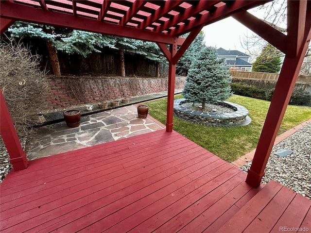 deck featuring a pergola and a lawn