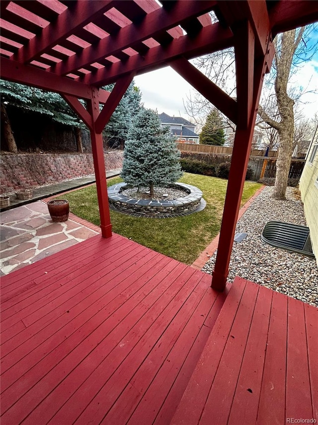 wooden terrace with a pergola and a lawn