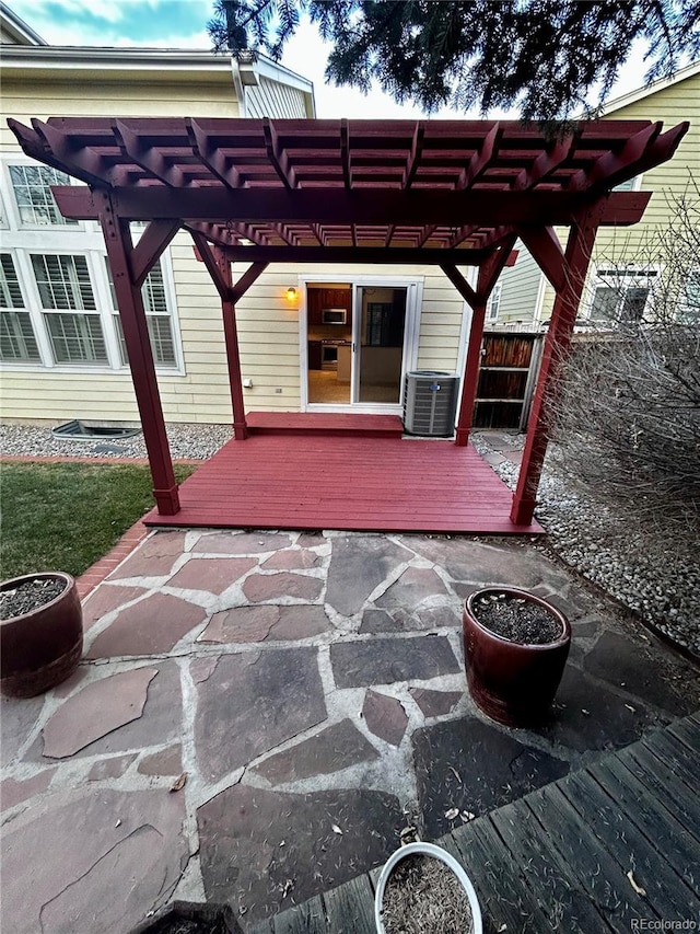 view of patio with a wooden deck, central AC unit, and a pergola