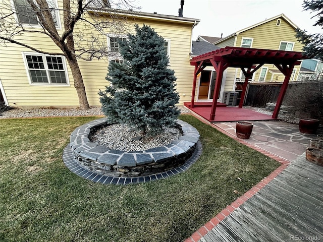 view of yard featuring a wooden deck, a pergola, and central air condition unit