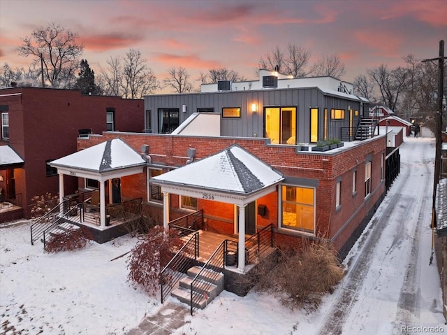 view of front of home with board and batten siding and brick siding