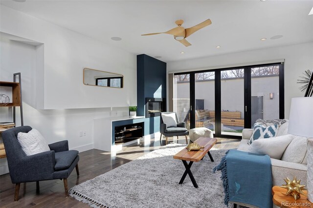 living area featuring dark wood-style floors, ceiling fan, baseboards, and recessed lighting