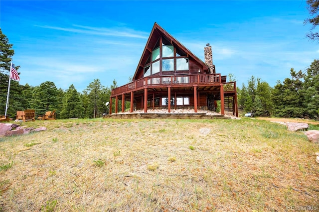 back of house featuring a wooden deck