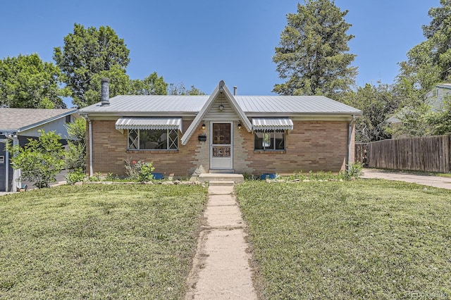 1750 S Dale Ct, Denver, CO 80219 - view of front of home featuring brick siding and a metal roof
