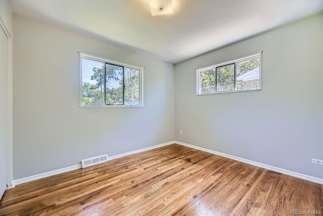1750 S Dale Ct, Denver, CO 80219 - spare room featuring baseboards and wood finished floors