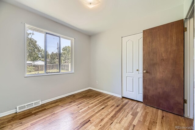 1750 S Dale Ct, Denver, CO 80219 - unfurnished bedroom with wood finished floors
