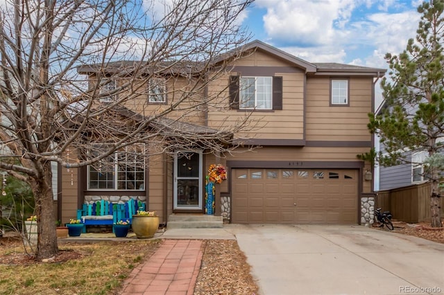 traditional-style home featuring an attached garage and concrete driveway