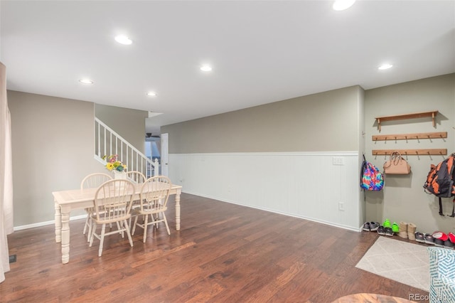 dining room featuring recessed lighting, stairway, wood finished floors, and wainscoting