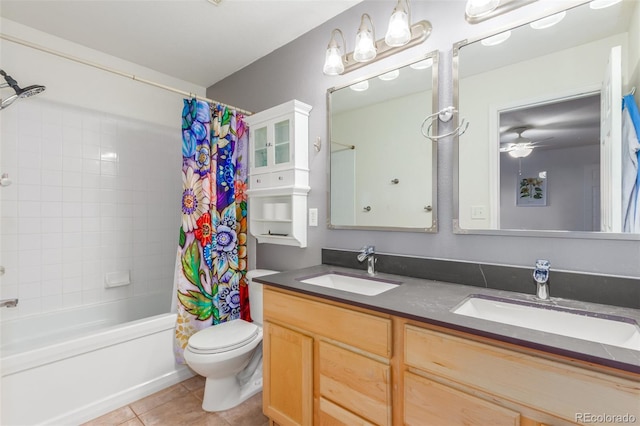 full bath with shower / bath combo, a sink, toilet, and tile patterned floors