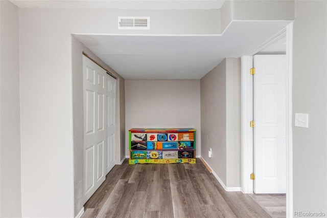 game room with visible vents, baseboards, and wood finished floors