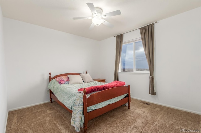 carpeted bedroom with visible vents, ceiling fan, and baseboards