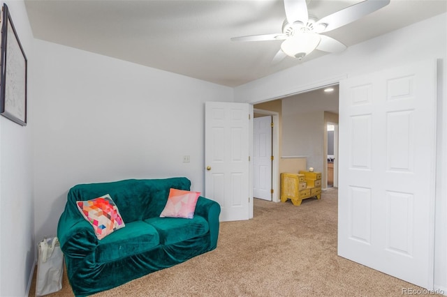 sitting room featuring light carpet and ceiling fan