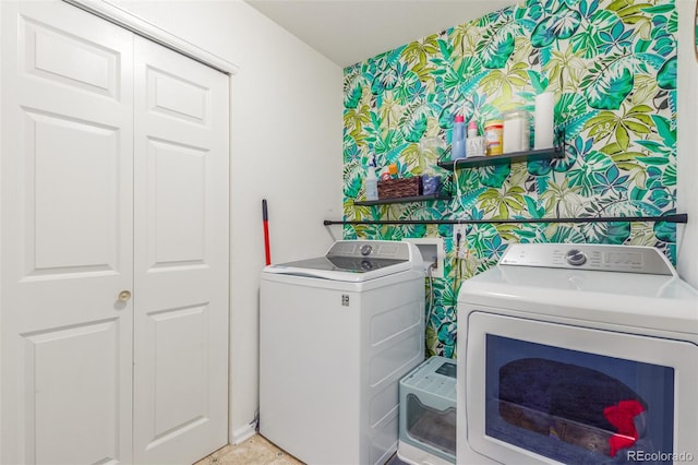 laundry room featuring laundry area, washer and clothes dryer, and wallpapered walls