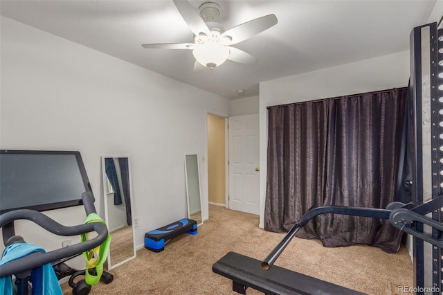 workout room with ceiling fan, baseboards, and carpet flooring