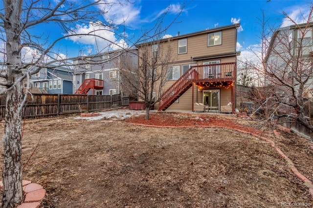 back of property featuring stairs, an outdoor fire pit, fence, and a wooden deck