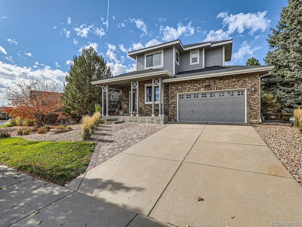 view of front of home with covered porch and a garage