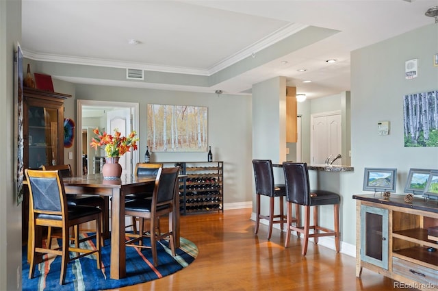 300 W 11th Ave Unit 15F, Denver, CO 80204 - dining space with baseboards, wood finished floors, ornamental molding, and recessed lighting