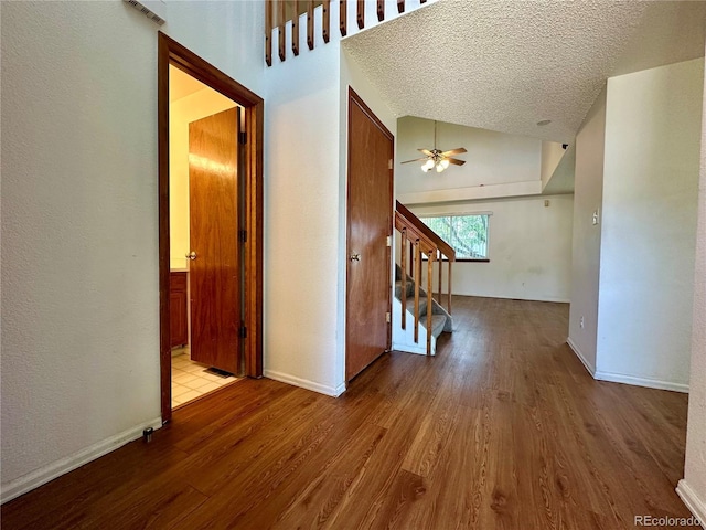 13191 Umatilla St, Denver, CO 80234 - corridor featuring wood finished floors, stairway, lofted ceiling, and a textured ceiling